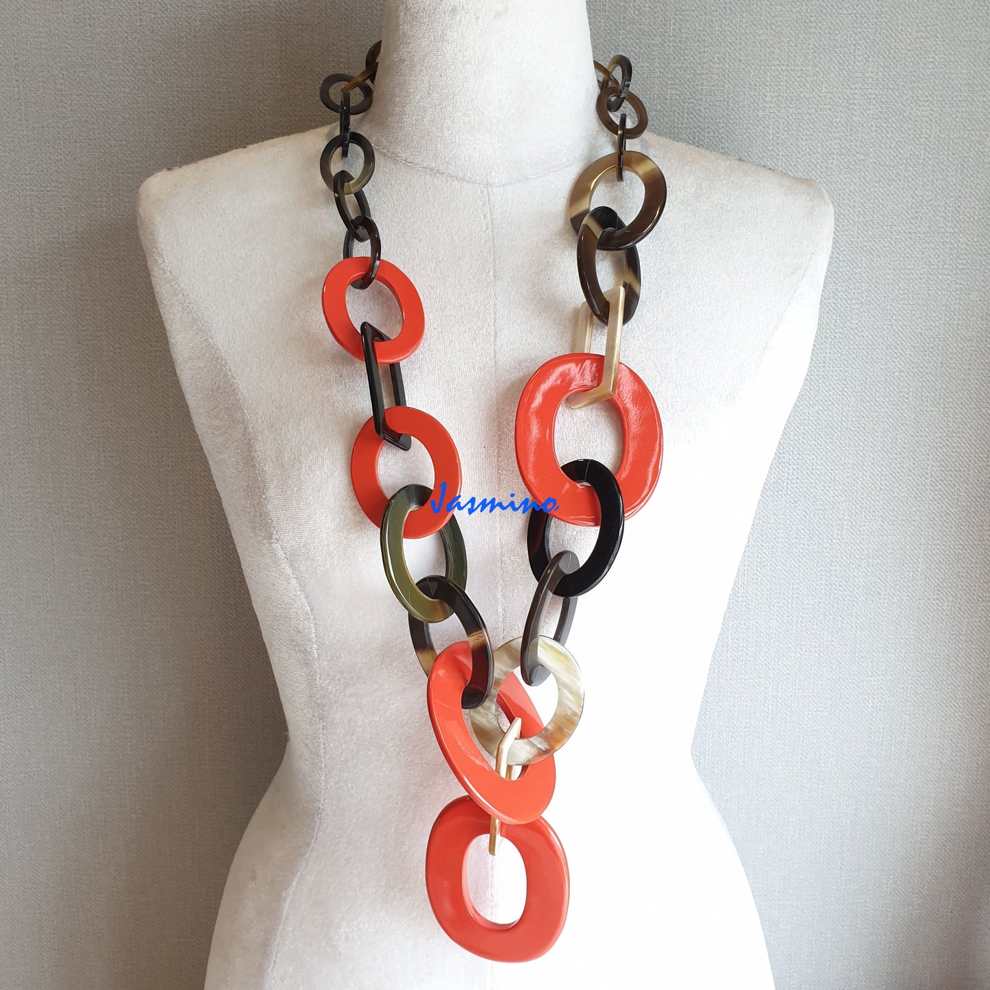 The necklace has several large orange peel pieces in natural light, impressive gift for her