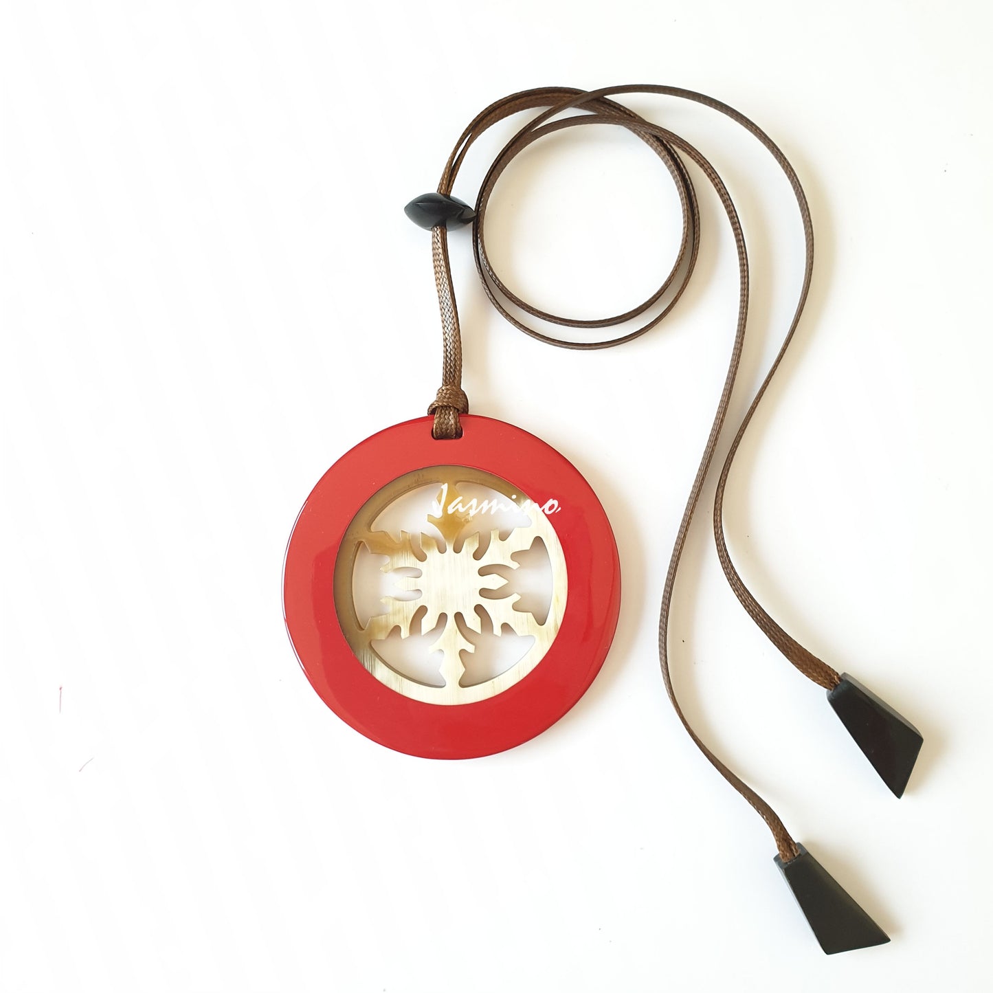 circular pendant is designed with orange peel outline, inside with snowflake pattern made of unique natural buffalo horn on a light background, impressive Christmas gift for her